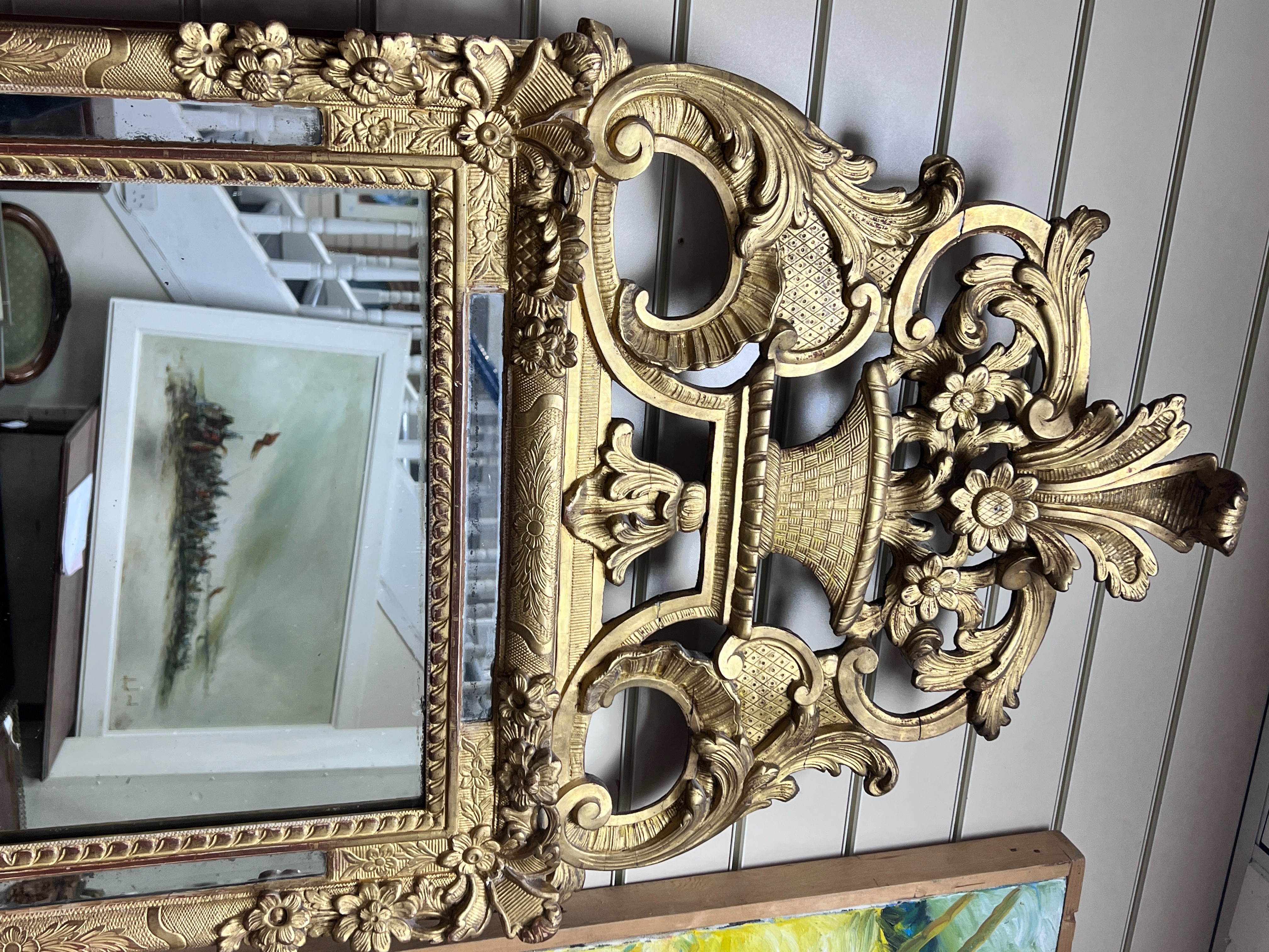 An early 19th century French carved giltwood and gesso wall mirror, W.60cm H.120cm